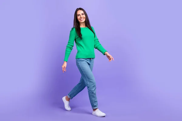 Full length profile side photo of young woman walking forward shopping store mall center isolated purple color background.