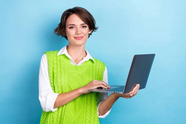 Photo of positive experienced online tutor teacher young woman wear formal uniform hold laptop internet specialist isolated on blue color background.