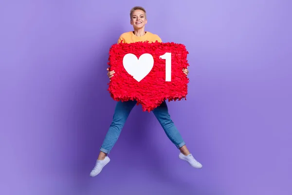 stock image Full size portrait of overjoyed cheerful girl jumping arms hold big like collage isolated on purple color background.