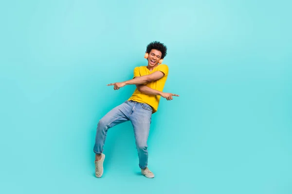 Full body photo of carefree overjoyed man have good moo dancing enjoy new playlist isolated on turquoise color background.