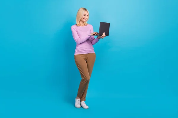 成功的积极女士穿着时髦衣服的全长照片打字文本现代设备空隙隔离蓝色背景 — 图库照片