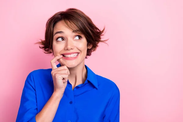 Closeup photo of young nervous business woman biting finger looking empty space guilty forgot turn off electricity isolated on pink color background.