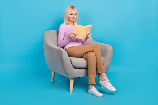 Photo of concentrated focused lovely lady wear trendy clothes reading new book interesting plot isolated on blue color background.