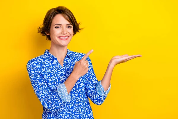 stock image Photo of pretty lovely lady wear trendy clothes arm demonstrate empty space banner interesting news isolated on yellow color background.