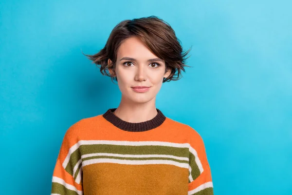 Photo of nice positive glad kind woman with short hairstyle dressed striped pullover looking at camera isolated on blue color background.