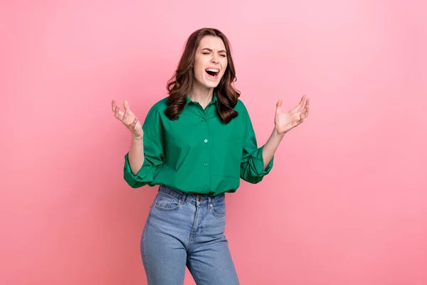 Photo of unhappy disappointed woman with wavy hairdo dressed green loudly scream shout yell eyes closed isolated on pink background.