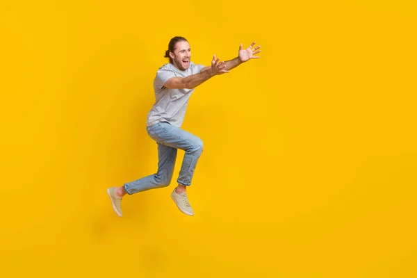 Full Length Photo Positive Excited Guy Dressed Grey Shirt Jumping — Zdjęcie stockowe