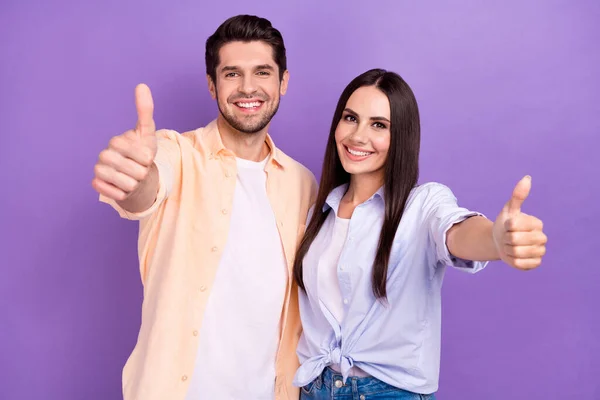 Photo of positive two young attractive woman with husband thumbs up recommend new freelance job website isolated on purple color background.