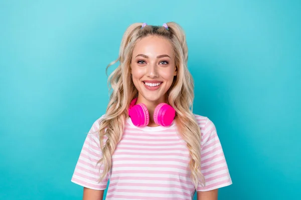 Portrait of lovely nice girl toothy smile headphones hang neck isolated on teal color background.