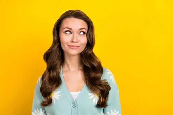 Photo of minded stunning positive person look interested empty space isolated on yellow color background.