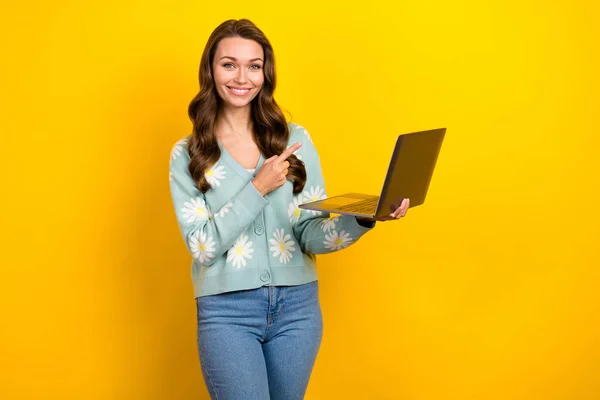 Creative photo advert of young satisfied student lady hold her new netbook direct finger new samsung gadget isolated on yellow color background.