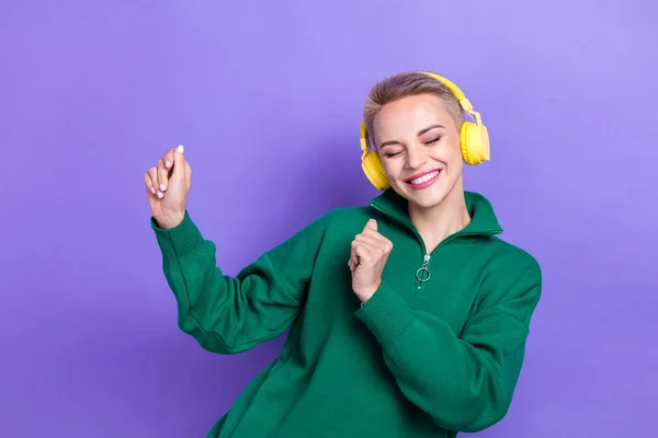 Portrait of carefree positive lady closed eyes toothy smile dancing enjoy listen new playlist isolated on purple color background.