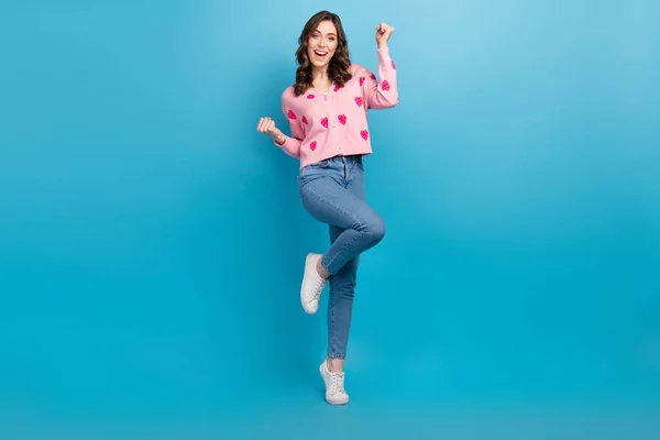 Full length photo of lovely lady raise fist lottery lucky dressed stylish pink strawberry print garment isolated on blue color background.