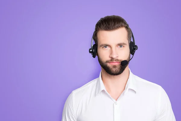stock image Portrait with copy space, empty place for advertisement of harsh virile operator having headset with microphone on head looking at camera isolated on grey background.