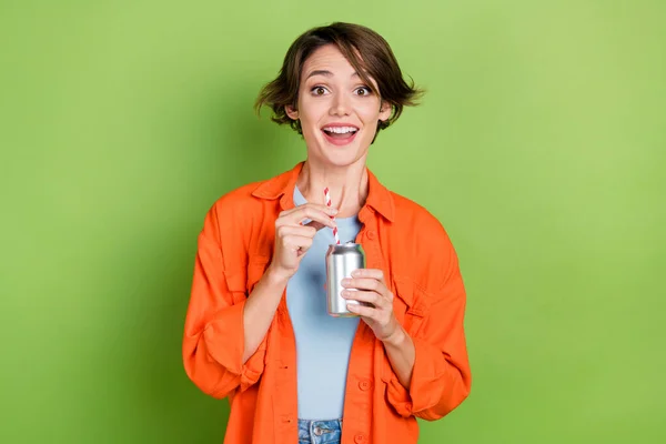 Photo of funky excited lady dressed jeans shirt enjoying cola can isolated green color background.