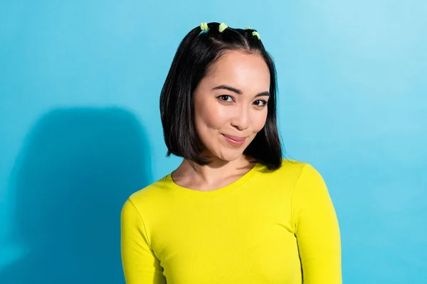 Photo portrait of cute japanese lady wear yellow shirt black ponytails hair smiling posing model daily makeup isolated on blue color background.