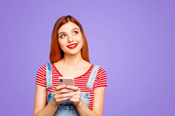 stock image Portrait of nice vivid girlish red straight-haired happy smiling minded young girl thinking about sms texting chatting conversation, isolated over blue background, copy space.