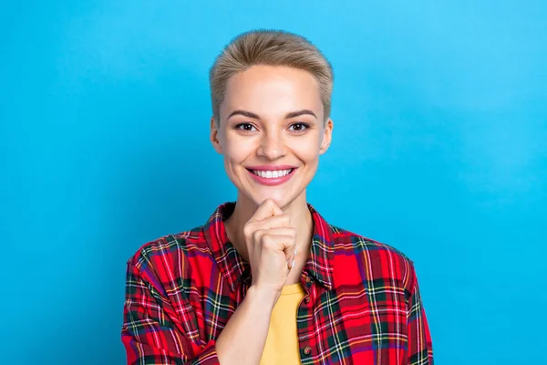 Portrait photo of cheerful positive woman touch chin thoughtful smart lady wear red plaid shirt enjoy her lifestyle isolated on blue color background.