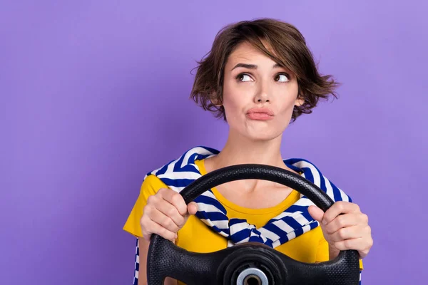 Photo of minded lady wear trendy striped clothes suspiciously look empty space hmm drive lesson test isolated on purple color background.