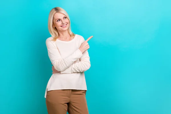 stock image Photo of confident promoter smiling pensioner businesswoman marketer wear white shirt indicate finger look mockup isolated on blue color background.