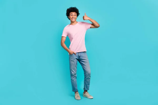 Full body size photo of young positive guy wear casual stylish outfit thumb up recommend his clothes brand isolated on aquamarine color background.