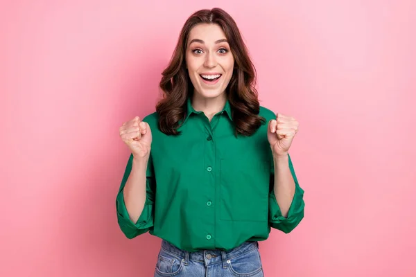 Photo of pretty excited lady dressed green blouse screaming rising fists isolated pink color background.