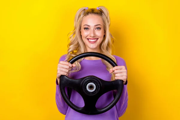 照片上漂亮而快乐的女士身穿紫色衬衫 微笑着享受驾驶车辆的乐趣 孤独的黄色背景 — 图库照片