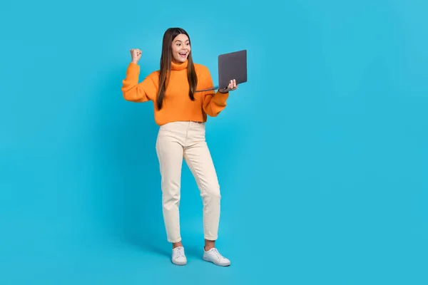 stock image Full length photo of glad delighted girl raise fist use netbook achievement isolated on blue color background.