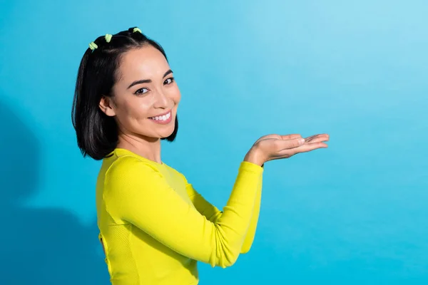 Profile photo cadre of young adorable chinese woman advertiser hold arms please donate charity support empty space isolated on blue color background.