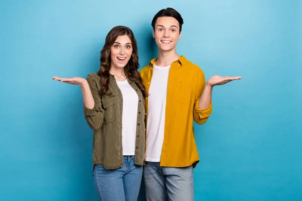 stock image Photo of stylish wearing clothes boyfriends with girlfriend hold arms empty space proposition choose best offer isolated on blue color background.