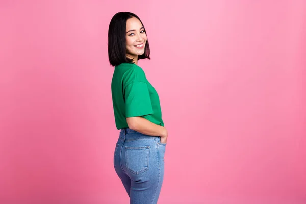 stock image Portrait of optimistic adorable woman with straight hairstyle oversize t-shirt demonstrate new clothes isolated on pink color background.