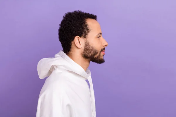 stock image Side profile photo of good mood pleasant guy with brunet beard wear white pullover look empty space isolated on violet color background.