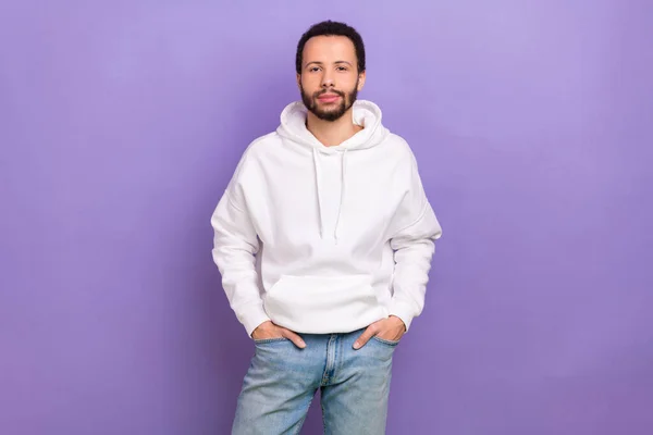 stock image Photo of calm attractive young man put arms pockets posing isolated on violet color background.