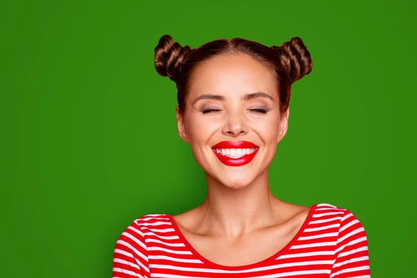 Close up the girls face with a wide smile and blinked eyes with happiness isolated on red bright background.