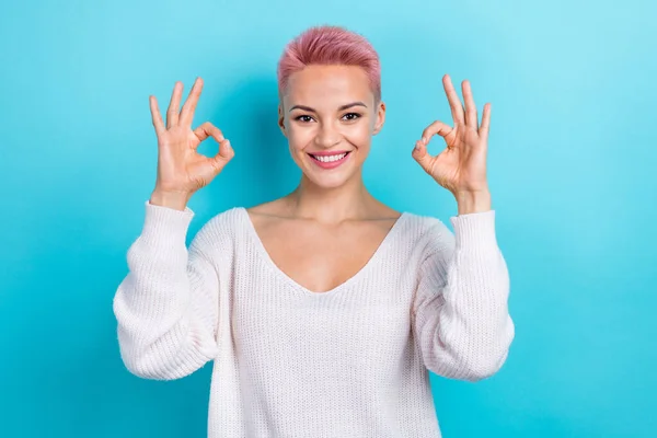 Photo portrait of positive good mood attractive lady show okey symbol good job done wear white jumper isolated on aquamarine color background.