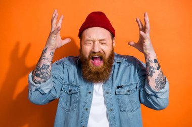 Photo of unsatisfied negative person closed eyes open mouth scream raise arms isolated on orange color background. clipart