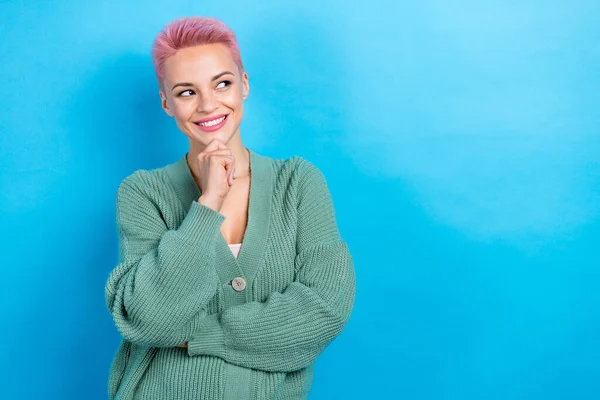 Photo of curious lady broker pink short hairdo look empty space wondered wear green cardigan isolated blue color background.