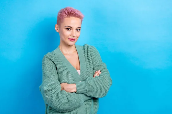Photo of young attractive serious business lady wear green cardigan folded hands posing avatar cadre isolated on blue color background.