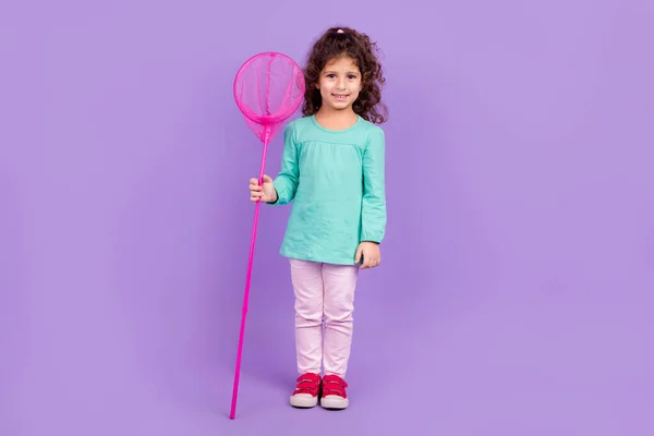 stock image Full length photo of pretty cute small kid wear turquoise shirt holding net ready catching butterflies isolated violet color background.