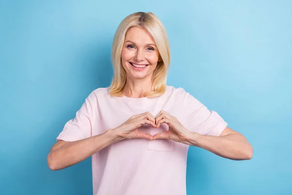 Photo of cheerful positive person straight hairdo dressed white t-shirt showing like symbol on heart isolated on blue color background.