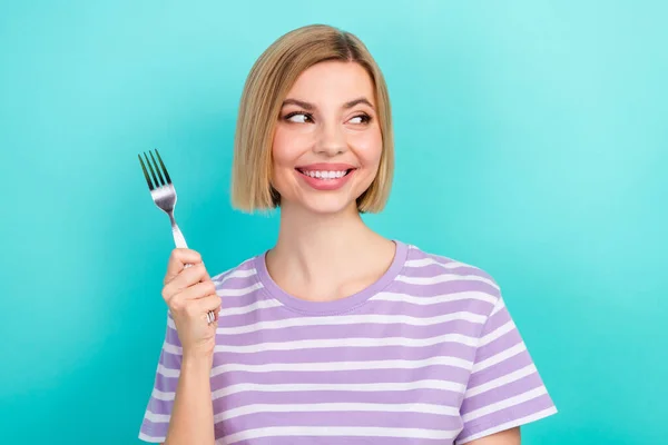 Photo portrait of young look interested mockup bob blonde hair girl hold fork want eat yummy meat steak isolated over cyan background.
