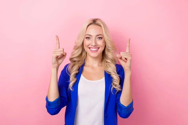笑顔楽観的な良い気分の女性の肖像は ピンクの色の背景に隔離された空のスペースプロモーター新聞広告を青色のブレザー直接指を着用 — ストック写真