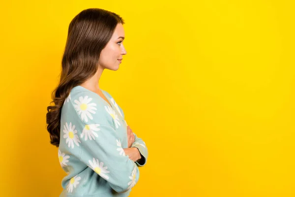 Profile photo of gorgeous positive person crossed hands look empty space isolated on yellow color background.