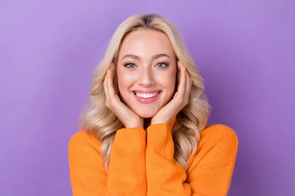 Photo of satisfied glad young person arms touch cheekbones beaming smile isolated on violet color background.