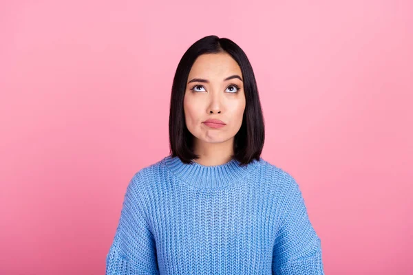 Portrait of minded girl look interested up above empty space contemplate isolated on pink color background.
