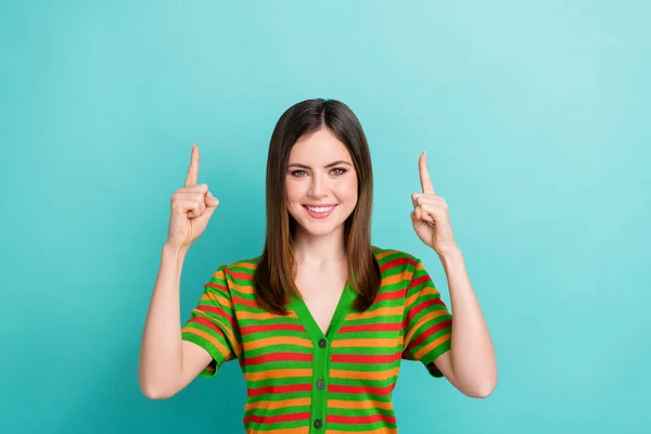 stock image Photo of sweet adorable woman dressed striped cardigan pointing two fingers up empty space isolated teal color background.