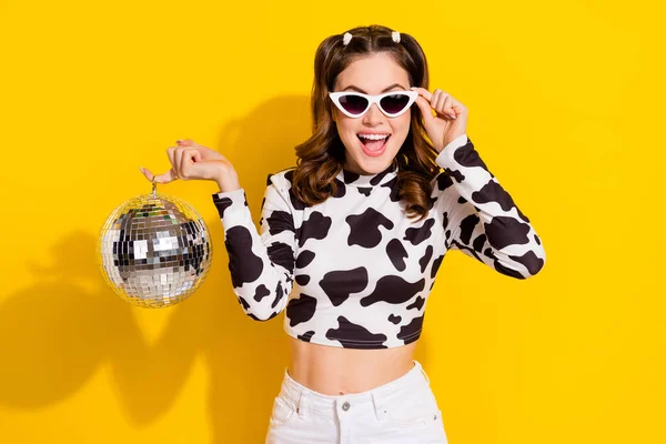 Photo of crazy youth lady hold disco ball enjoy weekend party wear black spot print clothes isolated shine color background.