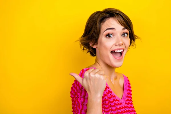 Photo of impressed ecstatic girl dressed off shoulder shirt indicating empty space amazing offer isolated on yellow color background.