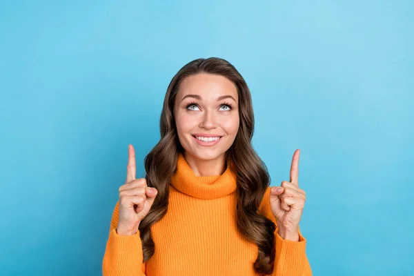 stock image Photo of shiny dreamy lady wear knitted pullover hand looking pointing two fingers up empty space isolated blue color background.