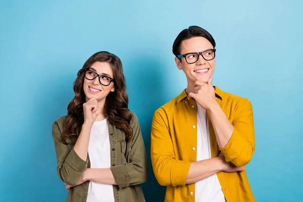 stock image Photo of dreamy funny married couple wear shirts spectacles looking empty space arm chin isolated blue color background